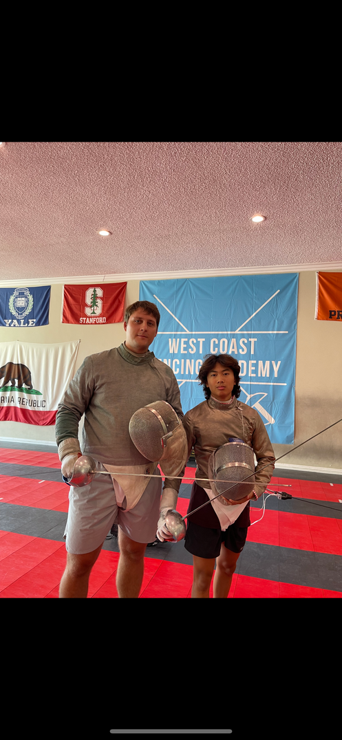 Coach Mike with Aidan Chan after their private lesson wearing their fencing gear