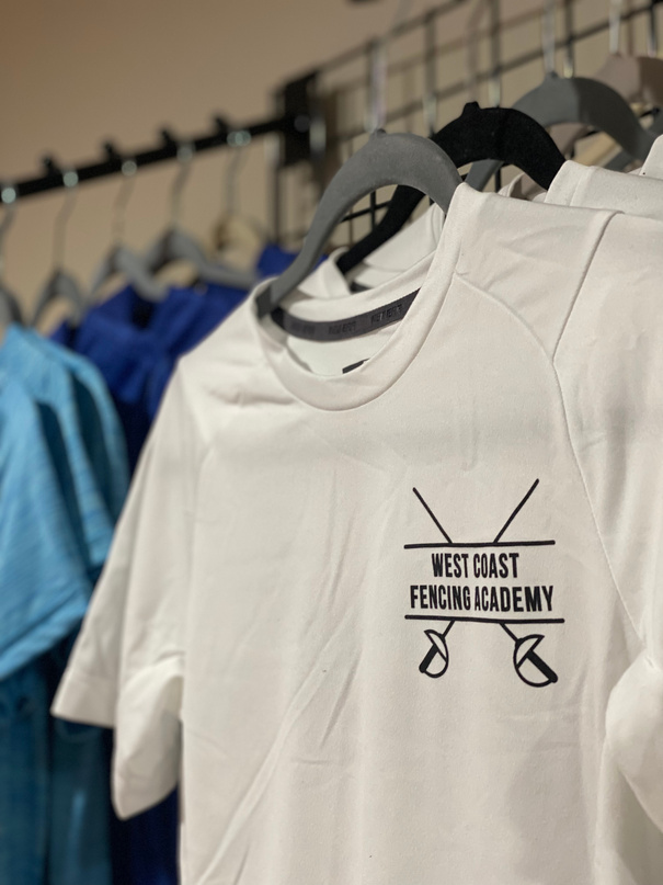 a white t - shirt with the words west cost fencing academy
